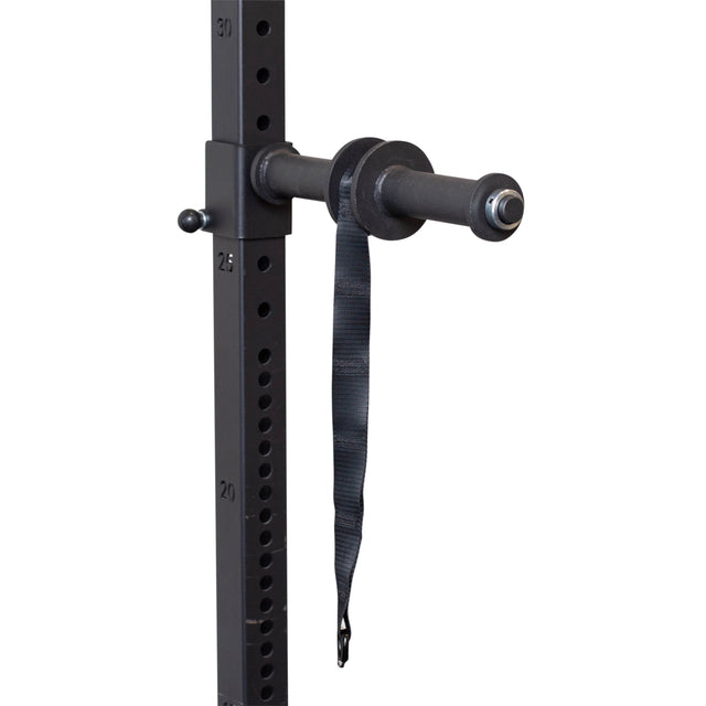 Close-up of Bells of Steel's Wrist Roller and Rack Attachment, a black weight plate holder on a gym rack. It hangs for grip strength enhancement. Numbered height markers on the rack ensure precise routine adjustments.