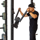 male athlete attaching Y Dip Bar Rack Attachment to a power rack