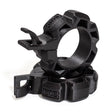 Two black, rugged Barbell Zip Clips - Half Standard (Pair) from Bells of Steel, circular with ridged edges and integrated clips, are stacked together on a white background, resembling standard barbell clips.
