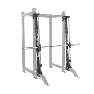 The Bells of Steel Smith Machine Rack Attachment is a silver and black metal power rack accessory with a barbell on sliding tracks, providing guided, stable weightlifting and reliable workout support.