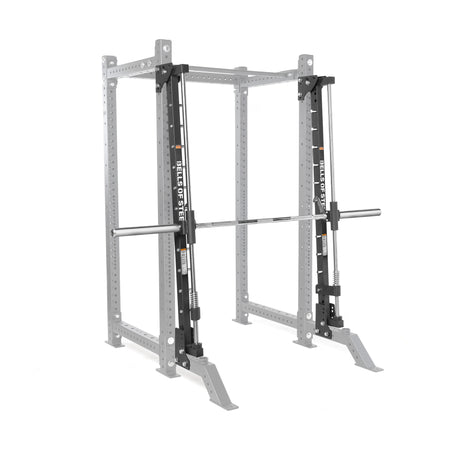 The Bells of Steel Smith Machine Rack Attachment is a silver and black metal power rack accessory with a barbell on sliding tracks, providing guided, stable weightlifting and reliable workout support.