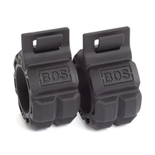 Two black, cylindrical rubber grips with textured surfaces and “Bells of Steel” embossed on each, these Barbell Zip Clips offer a rugged design ideal for improving your exercise or fitness equipment setup.