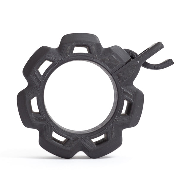 A front view of the Bells of Steel Barbell Zip Clips - Half Standard (Pair) shows a black, gear-shaped plastic ring with six outward notches and a hook, designed as a pressure-cuff, set against a white background.