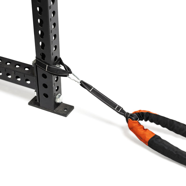 A close-up of Bells of Steel's Battle Rope, featuring an attached orange and black resistance band secured with a carabiner on a black metal workout rack. Set against a white background, this durable solution emphasizes essential fitness equipment for conditioning workouts.