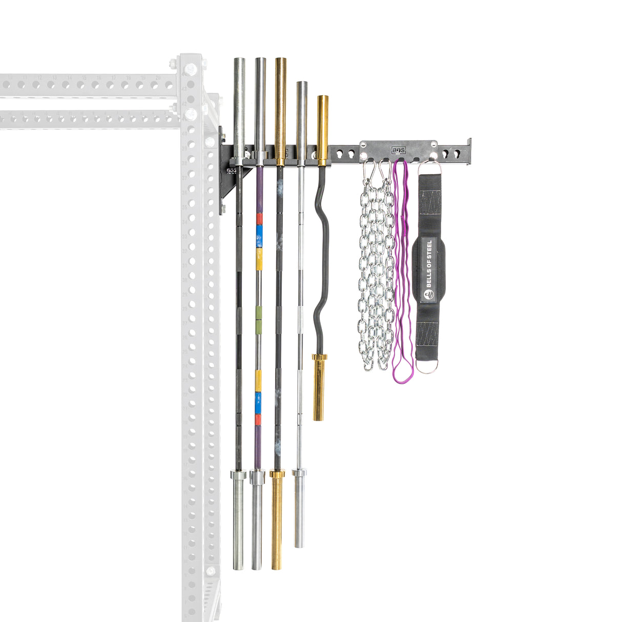 The Bells of Steel Utility Arm, securely fastened to the left wall stud with a sturdy metal frame, holds three straight barbells, a curl bar, chains, resistance bands, and a lifting belt. The equipment is neatly arranged vertically alongside a power rack.