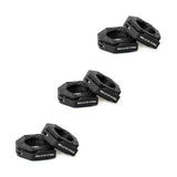 Three pairs of black hexagonal "Bells of Steel" weight plates are stacked diagonally on a white background, ideal for use with Bells of Steel Magnetic Clamp Collars to ensure secure and safe lifting.