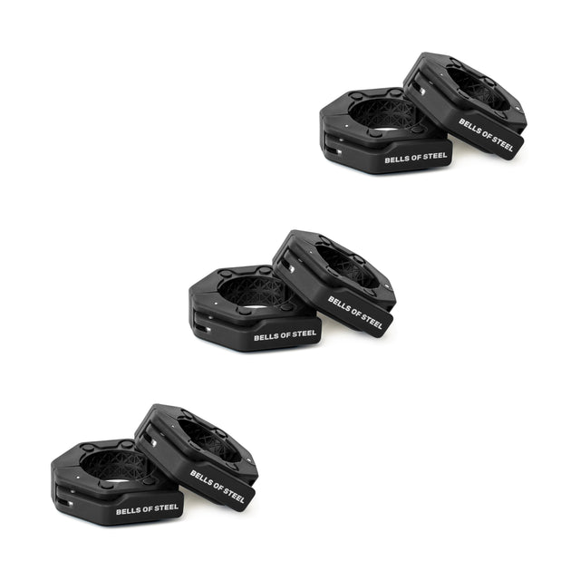 Three pairs of black hexagonal "Bells of Steel" weight plates are stacked diagonally on a white background, ideal for use with Bells of Steel Magnetic Clamp Collars to ensure secure and safe lifting.