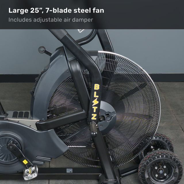 Side view of the Bells of Steel Blitz Max Air Bike, a commercial air bike with a 25-inch, 7-blade steel fan, "BLITZ" on the frame, and an adjustable air damper, set against a gray wall and floor.