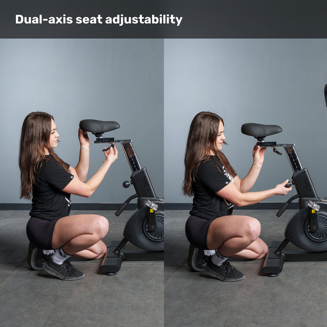 A woman demonstrates dual-axis seat adjustability on the Bells of Steel Blitz Max Air Bike by changing both seat height and horizontal position. Text at the top reads, "Dual-axis seat adjustability," against a plain gray wall background.
