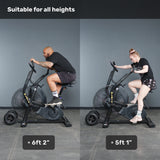 Two people of different heights use the Bells of Steel Blitz Max Air Bike, highlighting its adjustable design. Text reads: “Blitz Max Air Bike: built to fit all riders—ideal for any gym.”.