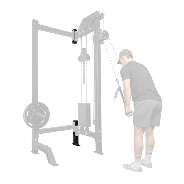 A man in athletic wear performs a tricep pushdown on a cable machine, with Bells of Steel USA's Rack Junctions - 3" x 3" visible in the customizable rack setup of his home gym.