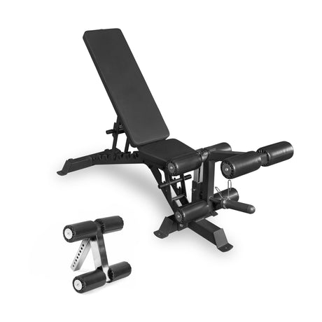 The Bells of Steel Buzz-Saw Heavy-Duty Adjustable Bench features a padded black seat and backrest, leg extension and curl attachments, plus a separate black foam roller nearby, offering versatile support for multiple workouts.