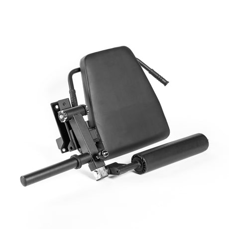 The Bells of Steel Leg Curl / Leg Extension Rack Attachment is a black, adjustable accessory with padded backrest and roller pads, ideal for leg or back workouts in a home gym. Shown on a white background.