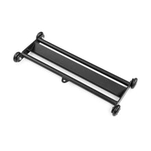 The Bells of Steel Glute Ham Slider features a black metal platform with four small wheels, ideal for ab rolls or hamstring exercises. Shown angled on a white background.