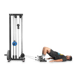 A man uses the Bells of Steel Glute Ham Slider, performing hamstring curls with bent knees and feet elevated on a platform, similar to cable machine exercises with foot attachments.
