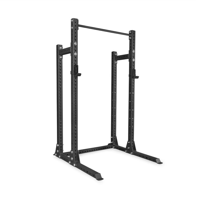 The Bells of Steel Hydra Half Rack Builder (3" x 3", ⅝" Holes), a black metal power rack with adjustable safety bars and a pull-up bar, is perfect for any home gym and stands against a white background.