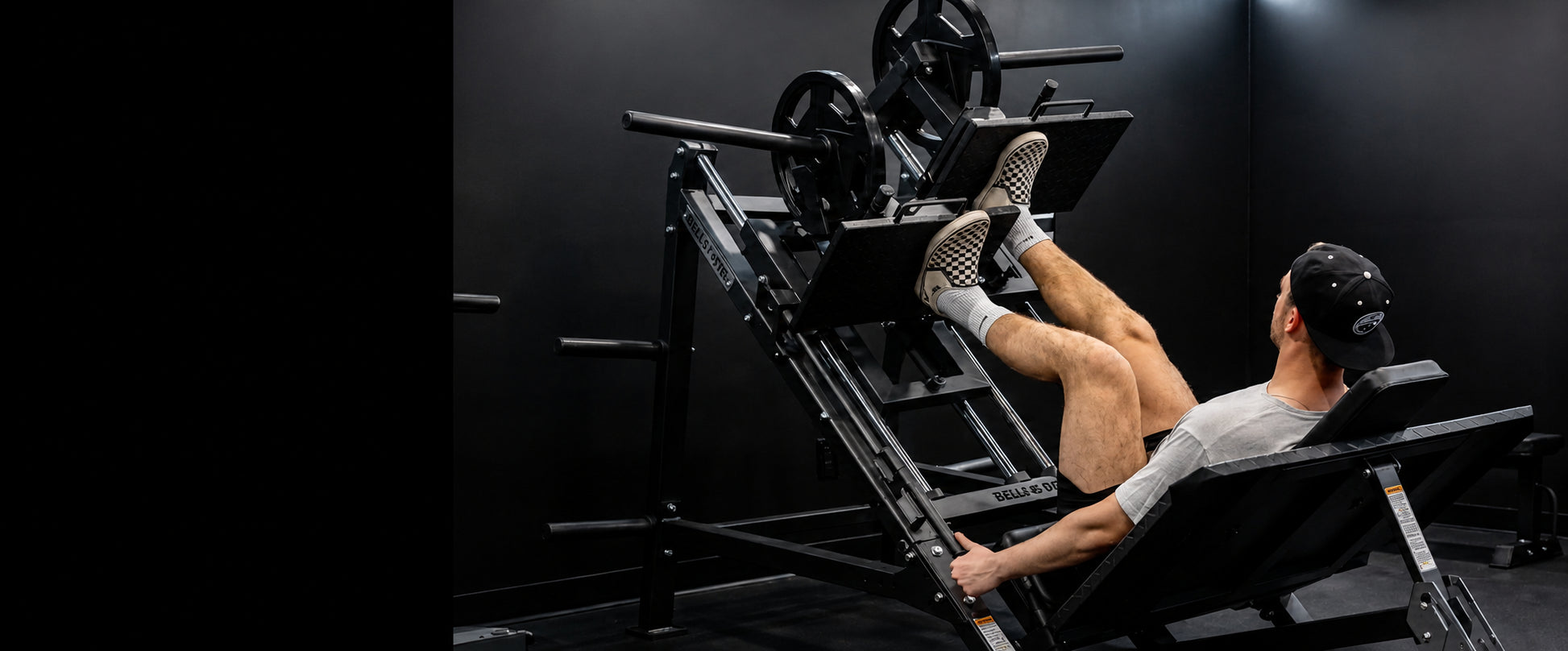 Person using a leg press machine in a gym setting