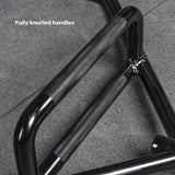 Close-up of the Bells of Steel Open Trap Bar / Hex Bar with two black, fully knurled handles on a grey stone floor. “Fully knurled handles” is displayed in the top left corner.