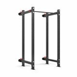 The Roc Foldable 4 Post Cage Builder by Bells of Steel, featuring 3" x 3" black metal posts, a pull-up bar, and adjustable safety bars. It's a freestanding modular power rack with bolt holes for stability, ideal for home or gym weightlifting.