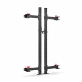 The Roc Foldable 2 Post Cage Builder by Bells of Steel, seen in a folded position against a white background, is ideal for home gyms. The design includes black steel beams with red accents and modular parts, featuring adjustable hooks and ⅝" holes for customization.