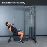 A man uses the Bells of Steel Lat Pulldown Low Row Machine for cable back training in a gym with a gray background. "Limited Lifetime Warranty" is displayed at the top.
