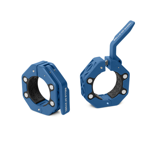 Two blue Magnetic Clamp Collars by Bells of Steel with geometric designs—one closed upright, one open with the lever raised. "BALL OF STEEL" is printed on the side, blending style and function in these weight plate collars.