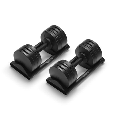 A pair of Bells of Steel USA NÜOBELL-S Adjustable Dumbbells with weight markings rest on matching black stands against a white background—ideal for any home gym.