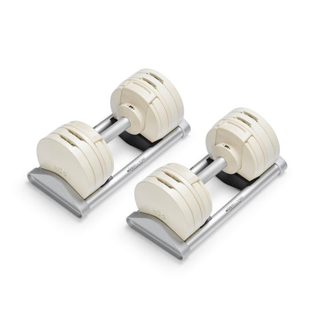 A pair of Bells of Steel USA NÜOBELL-S Adjustable Dumbbells with white plates and silver handles rest on silver trays, ideal for stylish home gyms and shown isolated on a white background.