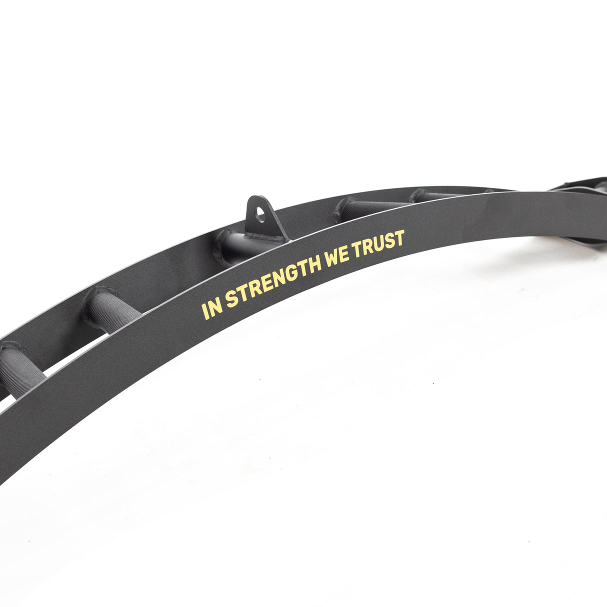 The Omni Bar by Bells of Steel features a black metal structure with "IN STRENGTH WE TRUST" in yellow letters and knurling details. It resembles part of a power rack or training equipment, set against a white background.