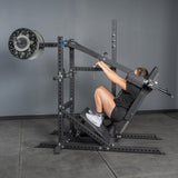 A person in athletic wear uses the Bells of Steel USA Pandemonium Squat – a 3-in-1 machine for pendulum squats, calf presses, and Viking presses—perfect for upgrading any home gym equipment setup.