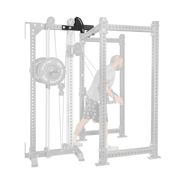 A man uses the Bells of Steel USA 3x3 Cable Tower to Rack Connection Kit for a cable exercise; the space-saving rack setup appears in gray, while the cable attachment and user are shown in full color for emphasis.