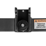 Close-up of a black metal hinge with bolt, attached to a bar. A warning label reads "TIGHTEN BEFORE EACH USE." Ideal as a rack attachment for the Bells of Steel Shoulder Boulder/Chest Fly Attachment.