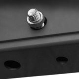 Close-up of a silver Hydra Hardware bolt by Bells of Steel, partially screwed into a black metal surface, with two circular holes visible in the foreground.