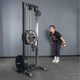 A person uses the Bells of Steel Extra Long Tricep Rope Extension (137cm) for tricep pushdowns on a cable machine in a gym, with a gray wall and floor in the background.