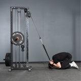 A person kneels, using the Bells of Steel Extra Long Tricep Rope Extension (137cm) attached to a weight machine to perform cable crunches, facing downward with their forehead close to the floor.